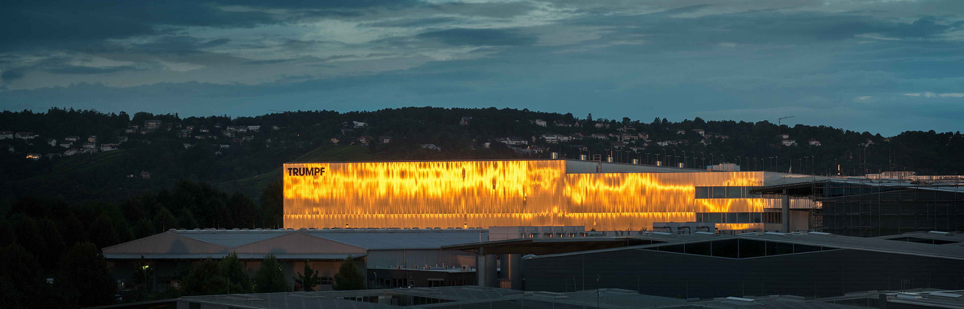 The Trumpf factory glowing brilliantly against the night sky