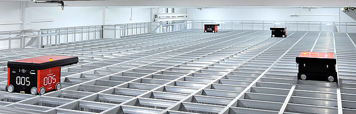 View from above of robots in an AutoStore warehouse