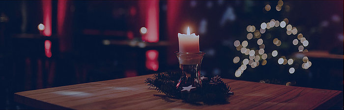 Burning candle in glass and dark background