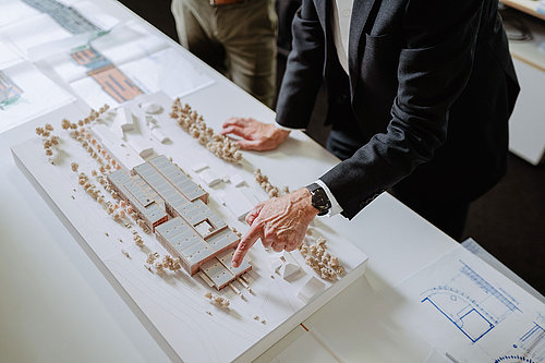 A finger pointing at a model of the Erbe logistics centre