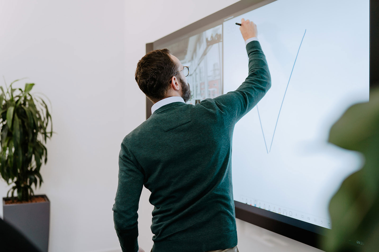 An employee works at a smartboard