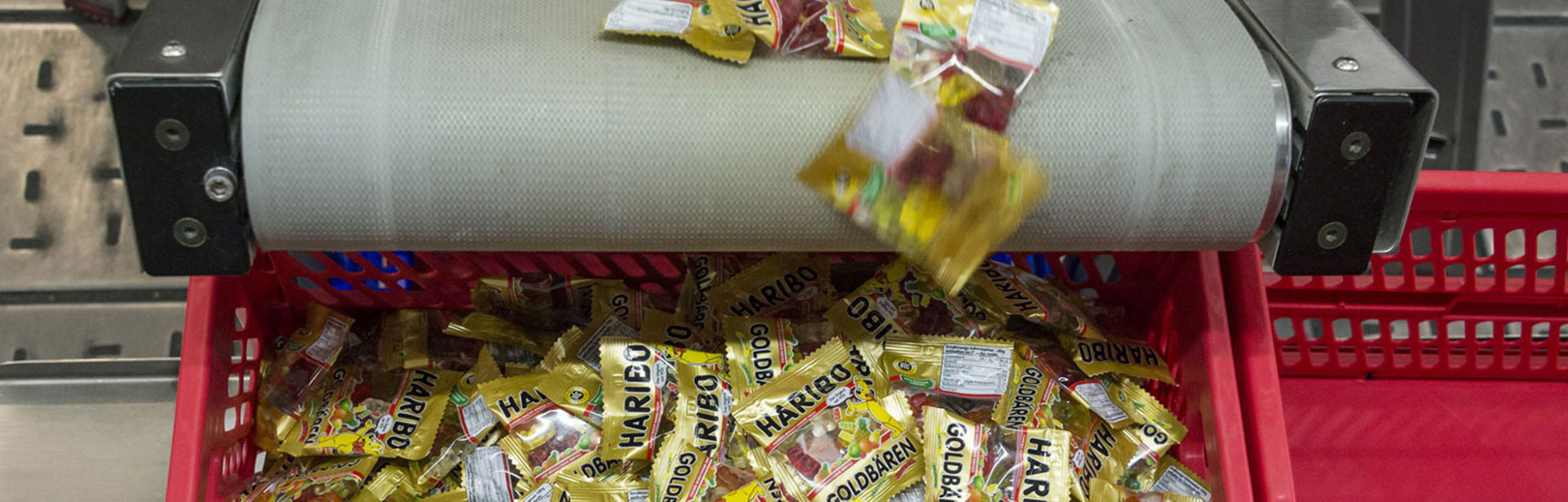 Haribo bags are sorted into boxes on an assembly line